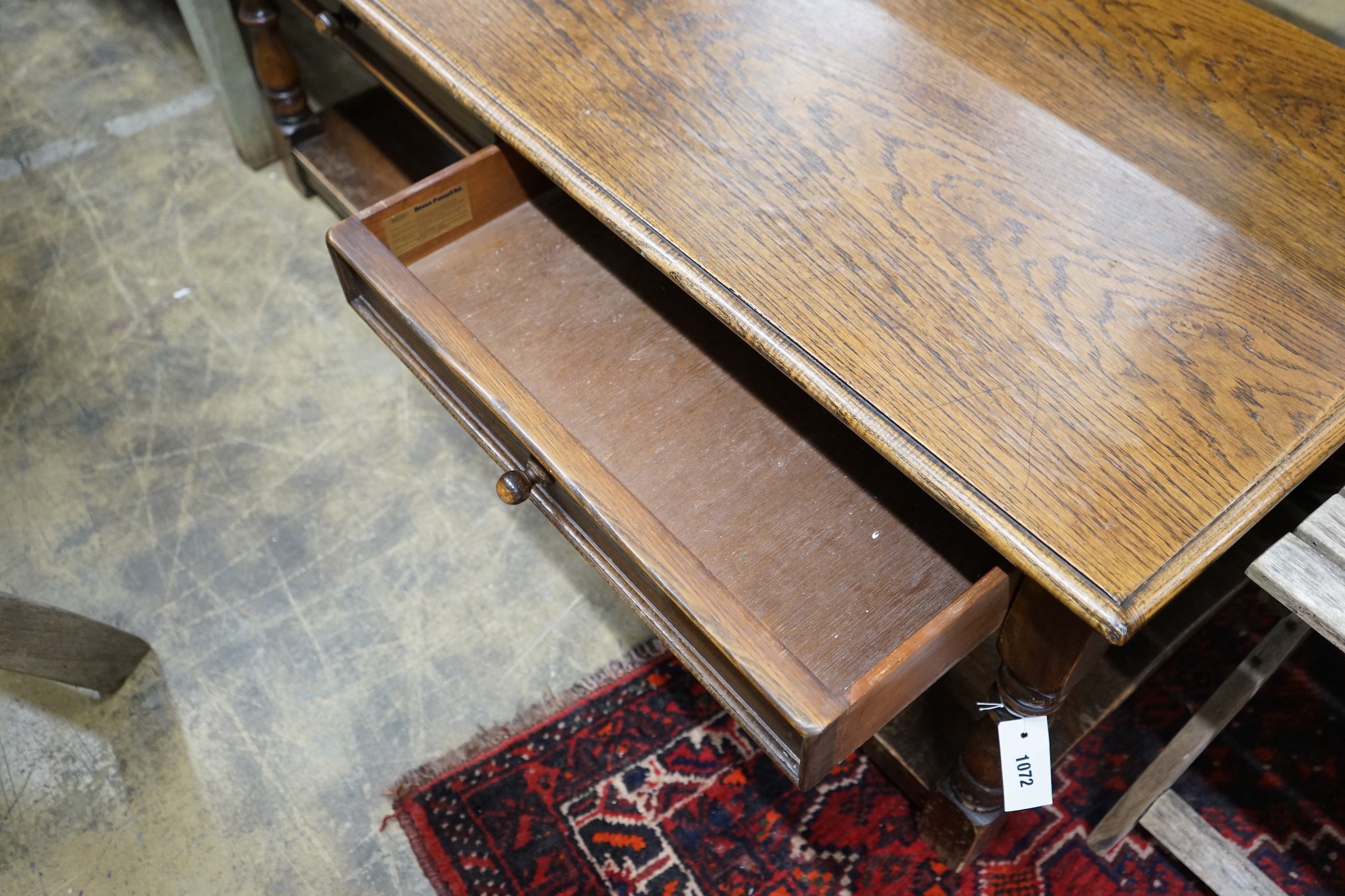 An 18th century style rectangular oak two tier coffee table, length 130cm, depth 62cm, height 50cm